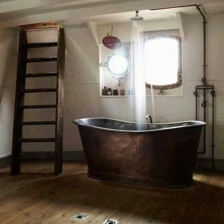 free standing hammered copper soaking tub with a rain shower head over it to give you another great bathroom makeover idea